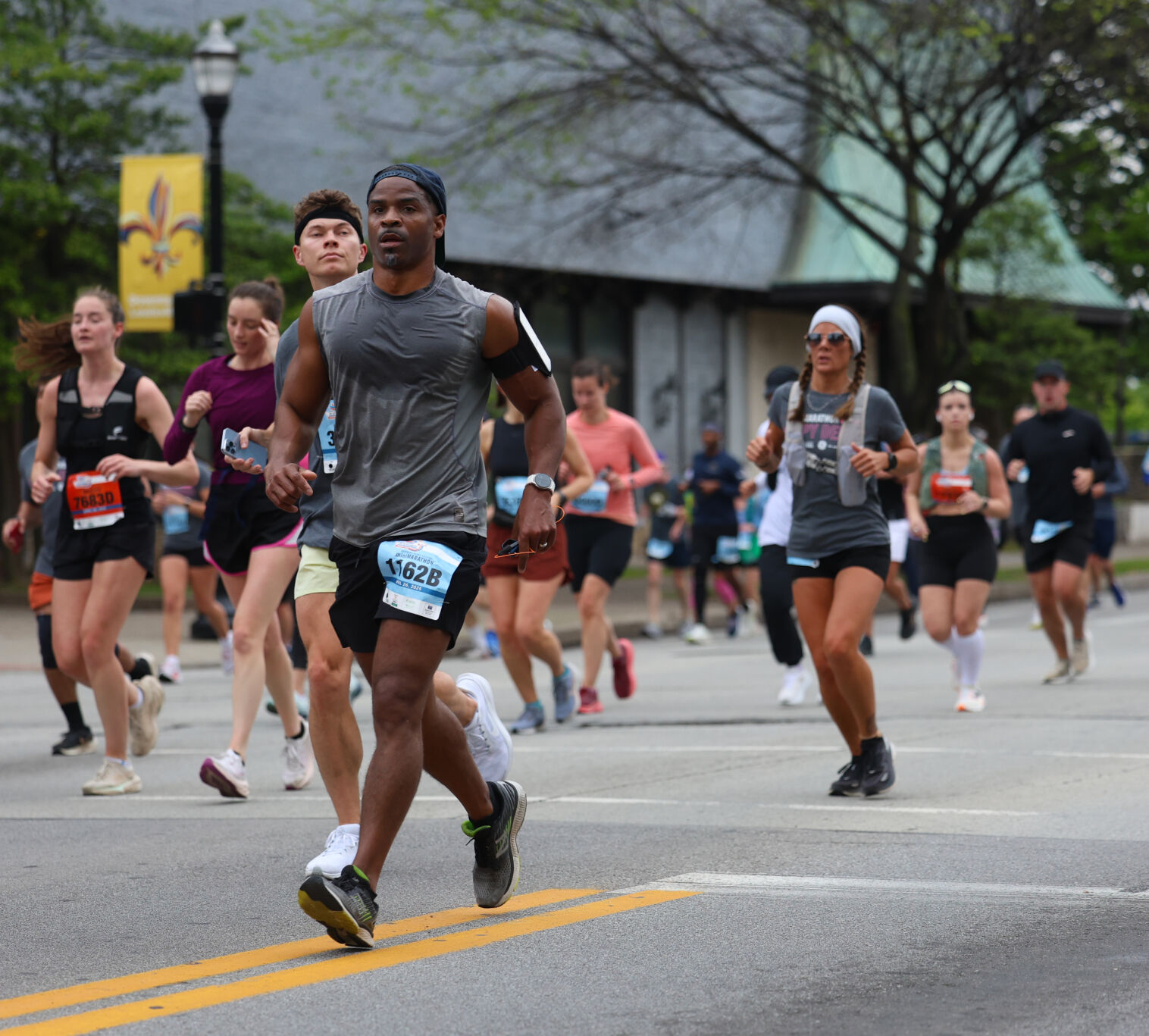 Runners go down Broadway during Marathon.JPG